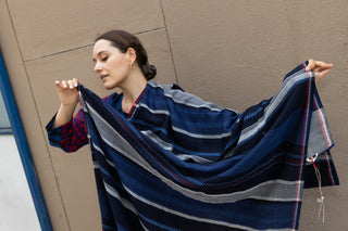 An accessory that beckons the autumn season. Extremely soft to the touch, the maxi handcrafted scarf from Injiri is a cold-weather staple. Made in India from merino wool, it features a rectangular shape and it measures 40" by 110".