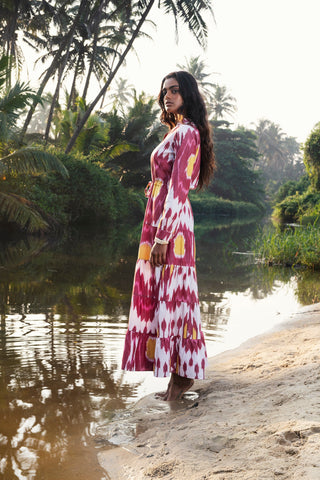 An instant hit, this Strawberry Pole-Pole from Kleed, ushering in the warm summer days and tropical evenings. A supremely flattering combination of berry crush and peachy pink, with irresistible sherbet yellow accents. We love the light single IKAT fabric, tapered line, elegant Mandarin collar, gathered sleeves buttoned at the cuff and gently flaring, four-tier flounces.